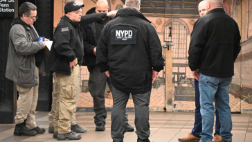 NYPD officers and other officials at Penn Station after a man was found on fire