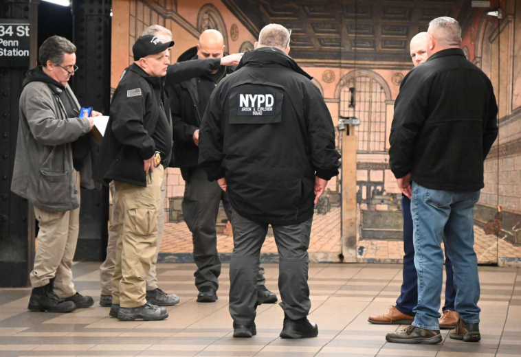 NYPD officers and other officials at Penn Station after a man was found on fire